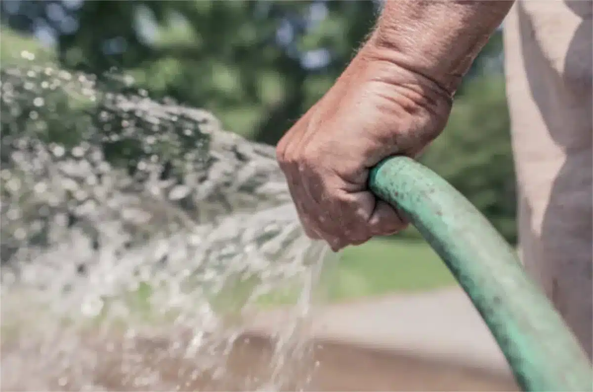 Filling the pump basket with pool water using a garden hose